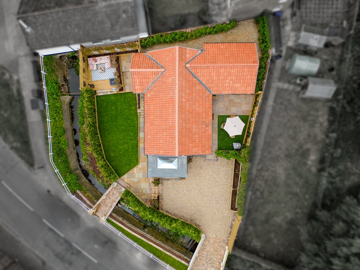 Aerial photograph highlighting the plot boundary, with everything beyond the boundary in black and white